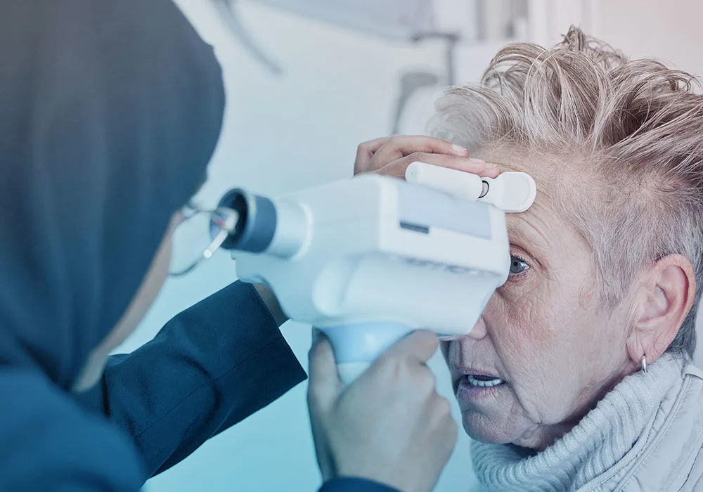 An eye specialist examining an elderly patient to check for early signs of cataract and cloudy vision